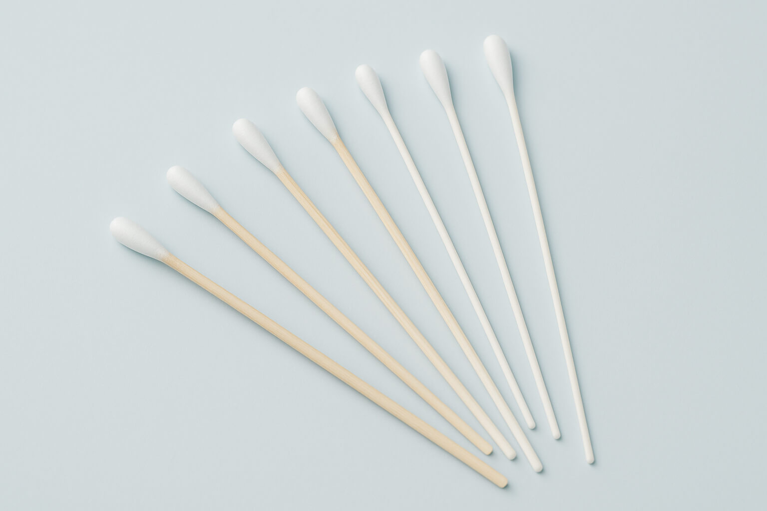 Side‑by‑side shot of three long cotton swabs next to a ruler